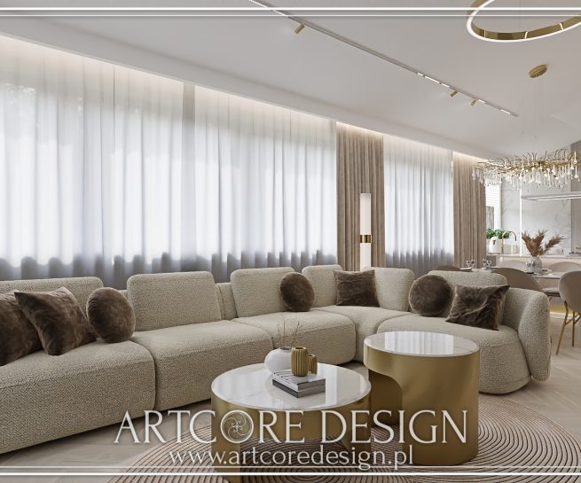 Nowoczesny salon z jasną sofą, złotymi stolikami, kuchnią w tle i designerskim oświetleniem.
